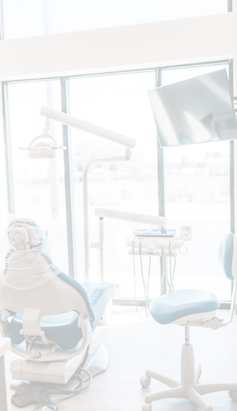 The image shows a modern dental or medical office interior with a dental chair, equipment, and a clean, professional environment.